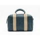 Bolso de mano estilo bowling en color azul petróleo con bandas frontales beige